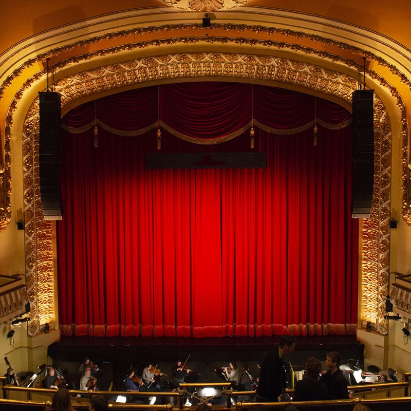 The proscenium of the Royal Theatre, with the red curtain down.